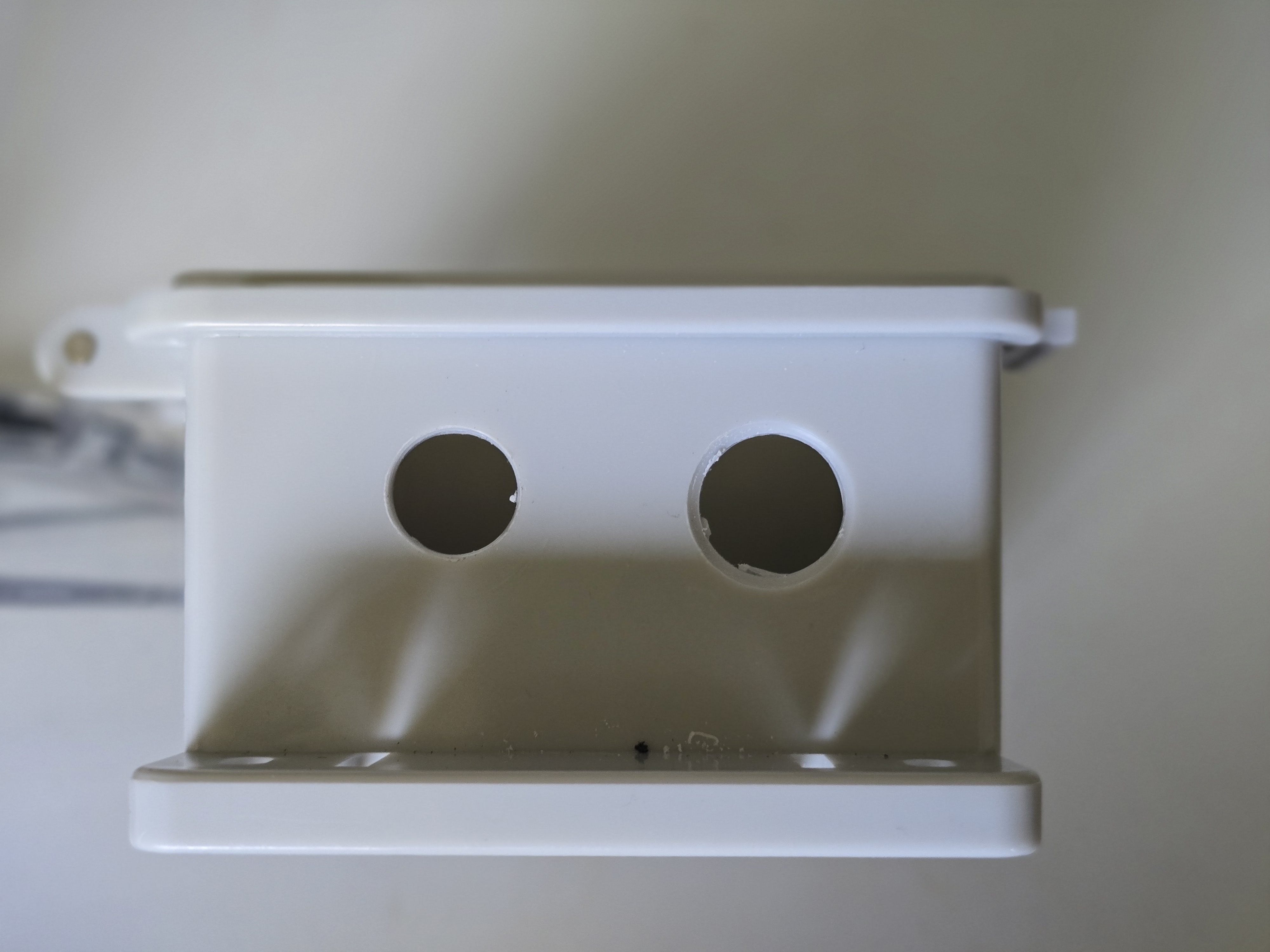 Holes drilled in bottom of enclosure for vent and cable gland